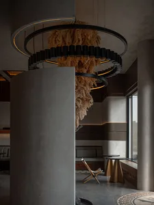 A warm and inviting dining space with a straw chandelier, comfortable seating, and natural elements