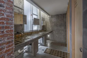 Modern bathroom with a marble countertop and sink area, giving off a luxurious vibe