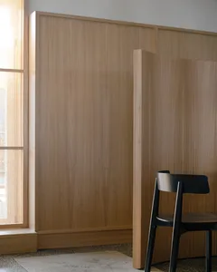 Empty dining room with wooden walls and floors, featuring a dining table and two chairs in a calm and inviting atmosphere