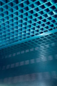 aqua-colored room with a blue tiled floor featuring a unique pattern of small squares and scattered tiles, creating a bright and inviting atmosphere