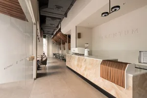 Modern restaurant interior with a marble countertop, multiple seating options, and a comfortable atmosphere