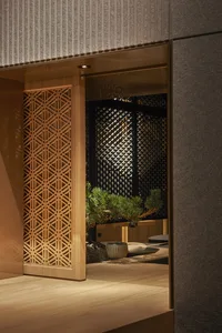 Warm and inviting interior design with wooden walls and floors, featuring potted plants and decorative vases