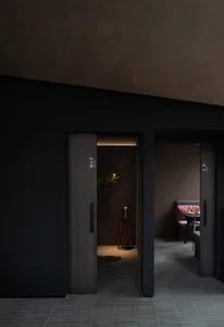 A well-organized hallway with two doors, a potted plant, and signs on the walls