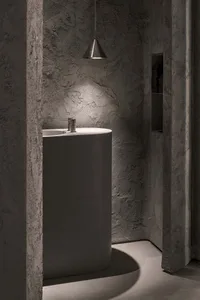 Bathroom with two sinks, stone walls, and a calm ambiance