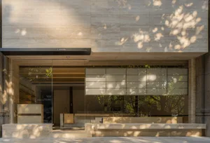 Bright public space with a large glass wall, benches, and natural light, featuring two cups near the center