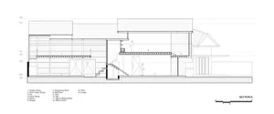 Architectural drawing of a modern building with various rooms and hallways, featuring clean lines and minimalistic design elements