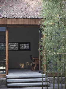 A small room with a wooden floor and a chair, creating a calm and inviting atmosphere
