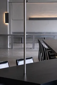 Empty restaurant with a long dining table and chairs, clean and well-organized space for social gatherings or business meetings