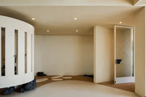 Empty beige hallway with carpeted floor, two doors on either side, and a calm atmosphere