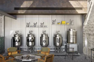 Industrial workspace with metal vats and chairs in a factory or warehouse setting, suggesting a functional and practical environment for productivity