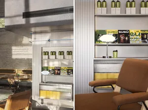 A well-lit cafe with a counter and chairs, bookshelves, and bottles, creating a warm and inviting atmosphere for dining and reading