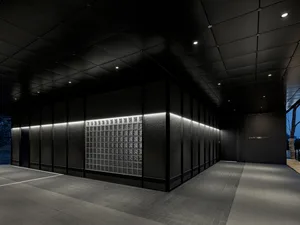 Empty modern hallway with black walls, square windows, and a minimalist atmosphere suggesting a recently renovated or under-construction building