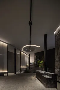 A well-designed interior space with a stone staircase, two potted plants, and a sense of sophistication