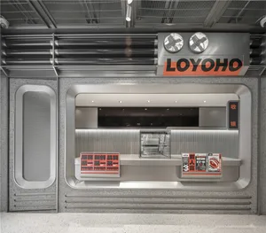 Modern lobby with silver walls, a grey floor, and two TV screens above a counter