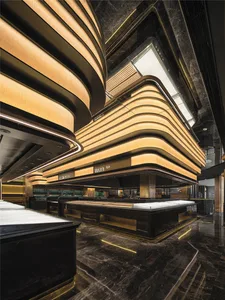 A modern lobby with curved walls and ceiling, well-lit and welcoming, featuring several people in a contemporary and stylish environment