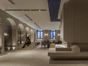 Elegant hotel lobby with high ceilings, multiple seating areas, and well-lit environment