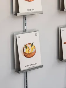 A display of food items in an Asian restaurant, with books on metal racks showcasing menu options