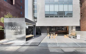 A public seating area with benches arranged around a building, creating a welcoming atmosphere with natural surroundings