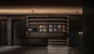 A dimly lit library or store with numerous books arranged on wooden shelves in various sizes and heights, creating a cozy atmosphere