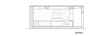 Empty modern kitchen with white cabinets, black countertops, and a focus on simplicity and efficiency