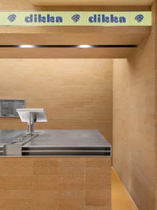 Industrial kitchen with stainless steel sink and wood countertop, two sinks, and a functional atmosphere