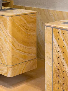 A modern bathroom with two marble countertops, clean lines, and minimalist design, illuminated by natural light