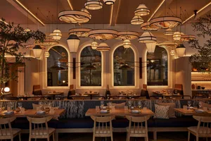 Warm and inviting restaurant interior with wooden tables and chairs, natural lighting, and cozy ambiance