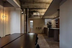 Industrial kitchen with a dining table and chairs, a functional and practical space with a focus on efficiency in food preparation and storage