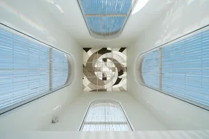 A bright and airy space with two prominent arches, large windows, and a minimalist appearance