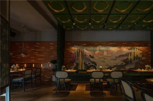Modern restaurant interior with wooden floors and walls, multiple dining tables, and comfortable seating