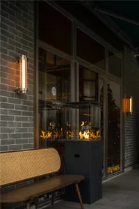 A modern living space with a metal fireplace, a bench, and warm atmosphere