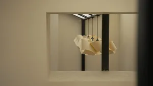 Interior view of a modern room with wooden lighting fixtures suspended at different heights