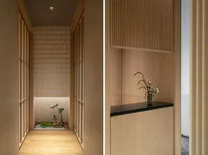 A well-lit room with wooden floors and walls, featuring a potted plant and decorative vase, creating a warm and inviting atmosphere