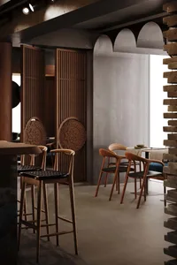 An empty restaurant interior with wooden chairs and tables, dimly lit for a relaxing ambiance