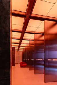 Sleek modern lobby with glass doors, two chairs, and a focus on openness and functionality