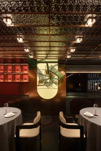 Elegant dining space with a large dome, chairs, and a dining table, set in a sophisticated environment