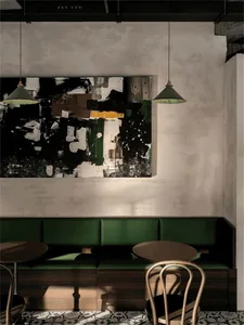 Inviting restaurant interior with green benches and tables, creating a comfortable dining experience