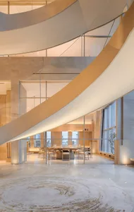 Well-lit dining area with tables and chairs, natural light from windows, and a modern design