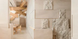 Contemporary interior space with a large marble wall, two chairs, and a sophisticated atmosphere