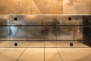 Modern kitchen with metallic walls and countertops, stainless steel appliances, and marble countertops