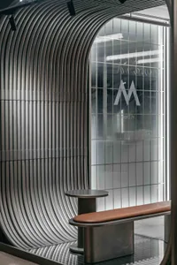 A modern interior design featuring a wooden and metal bench in front of a glass wall with a logo, set against a neutral background