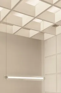 Empty white room with a large ceiling, concrete walls, and a minimalist appearance