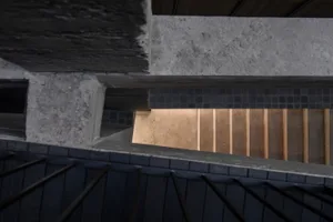 A daytime photo of a concrete staircase with a functional and practical design, set against a neutral background