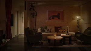 Cozy living space with a couch, chair, table, and potted plants, adorned with a painting and a vase, creating a warm and inviting atmosphere