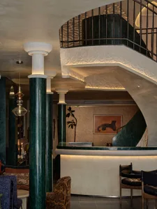 A modern interior design featuring a spiral marble staircase leading to a second floor, with a luxurious and elegant ambiance