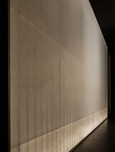 A textured cement block wall with a brownish hue, set against a neutral background