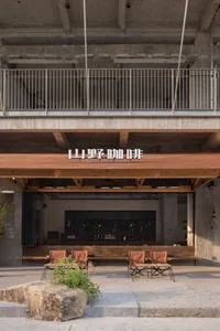 A wooden dining table surrounded by chairs in a cozy restaurant setting with warm ambiance