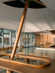Inviting restaurant interior with wooden tables and chairs, warm and cozy atmosphere
