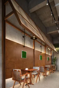 A warm and inviting dining area with wooden tables and chairs, featuring cups and a cozy atmosphere