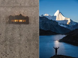 A man stands on a rocky cliff overlooking mountains, with an architectural scene featuring two signs and a bench in the foreground